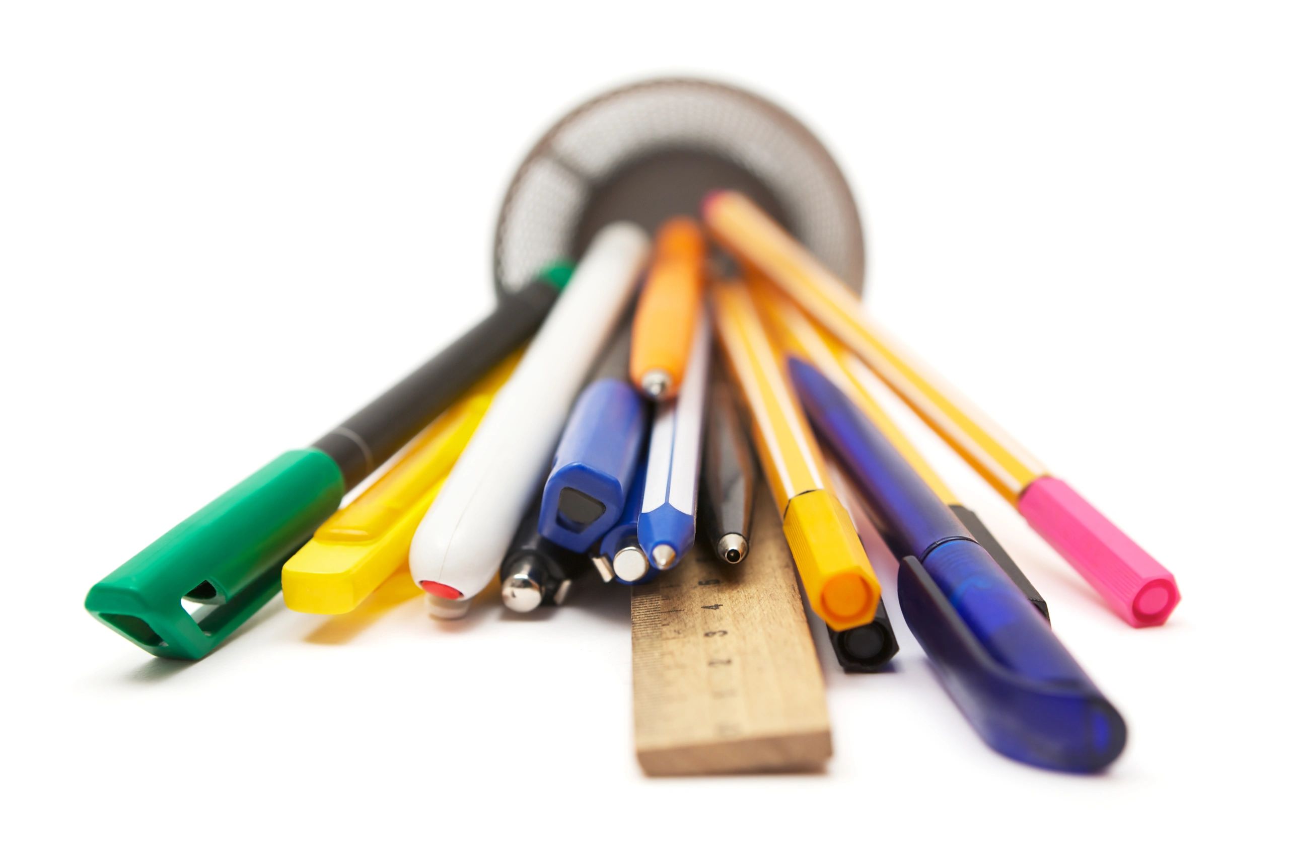 Assorted pens in a tipped-over pen holder