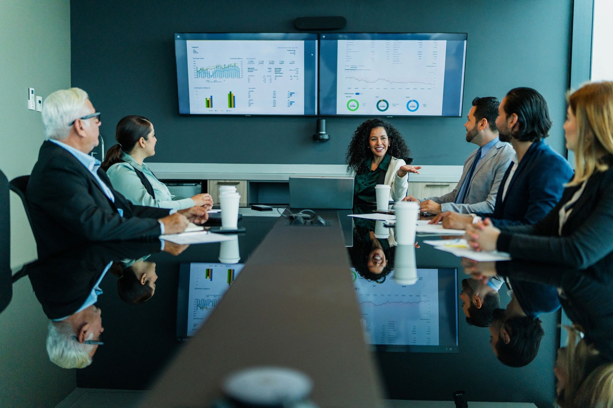 Professional woman speaking with coworkers in an office