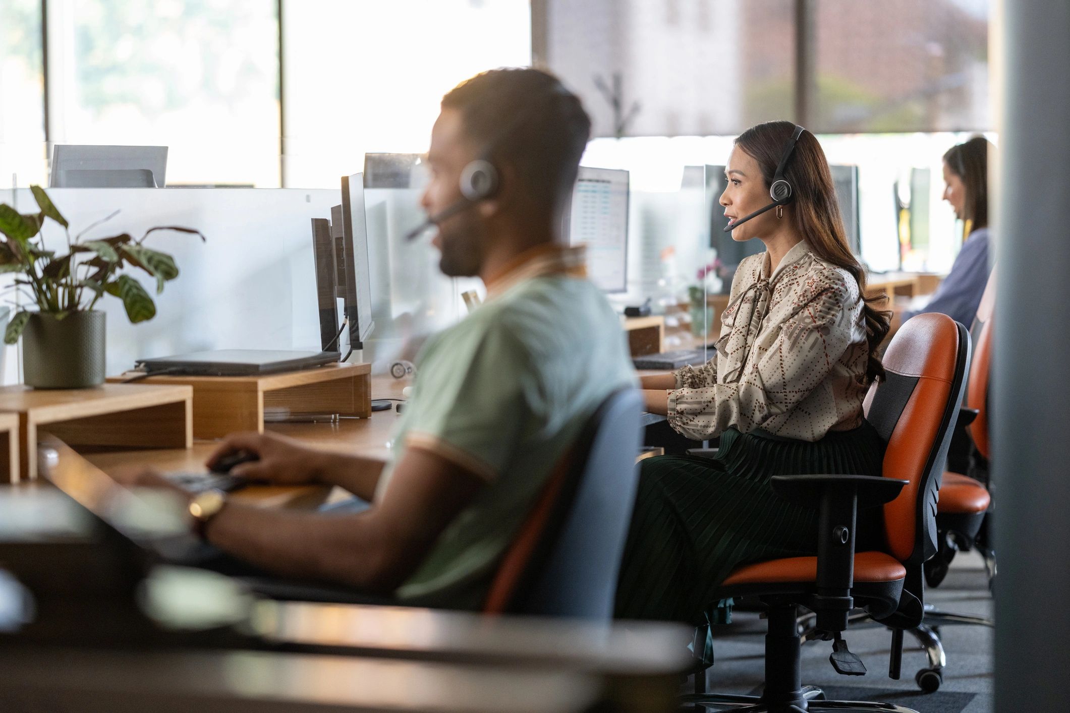 Customer service representative wearing a headset at a call center